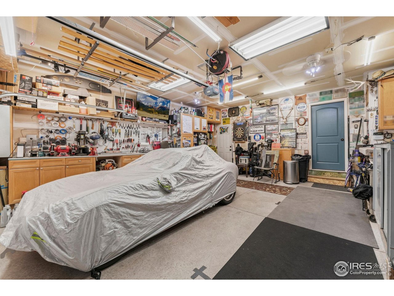 11420 Coal Ridge Street Firestone, CO 80504 - Photo 21 of 31 a living room with a bed and a chandelier