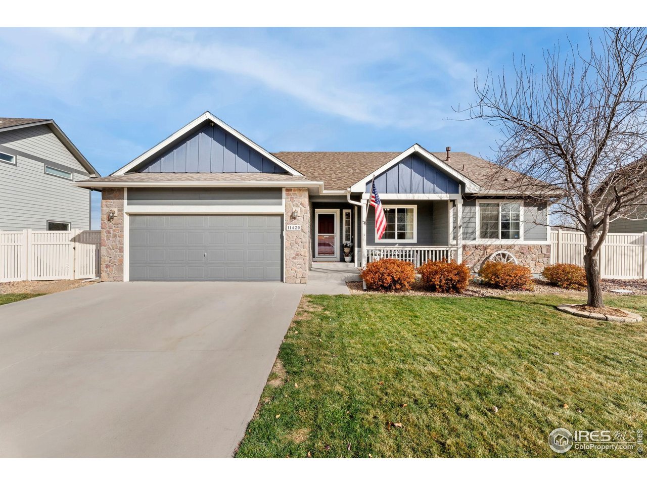 11420 Coal Ridge Street Firestone, CO 80504 - Photo 3 of 31 a front view of a house with a yard and garage