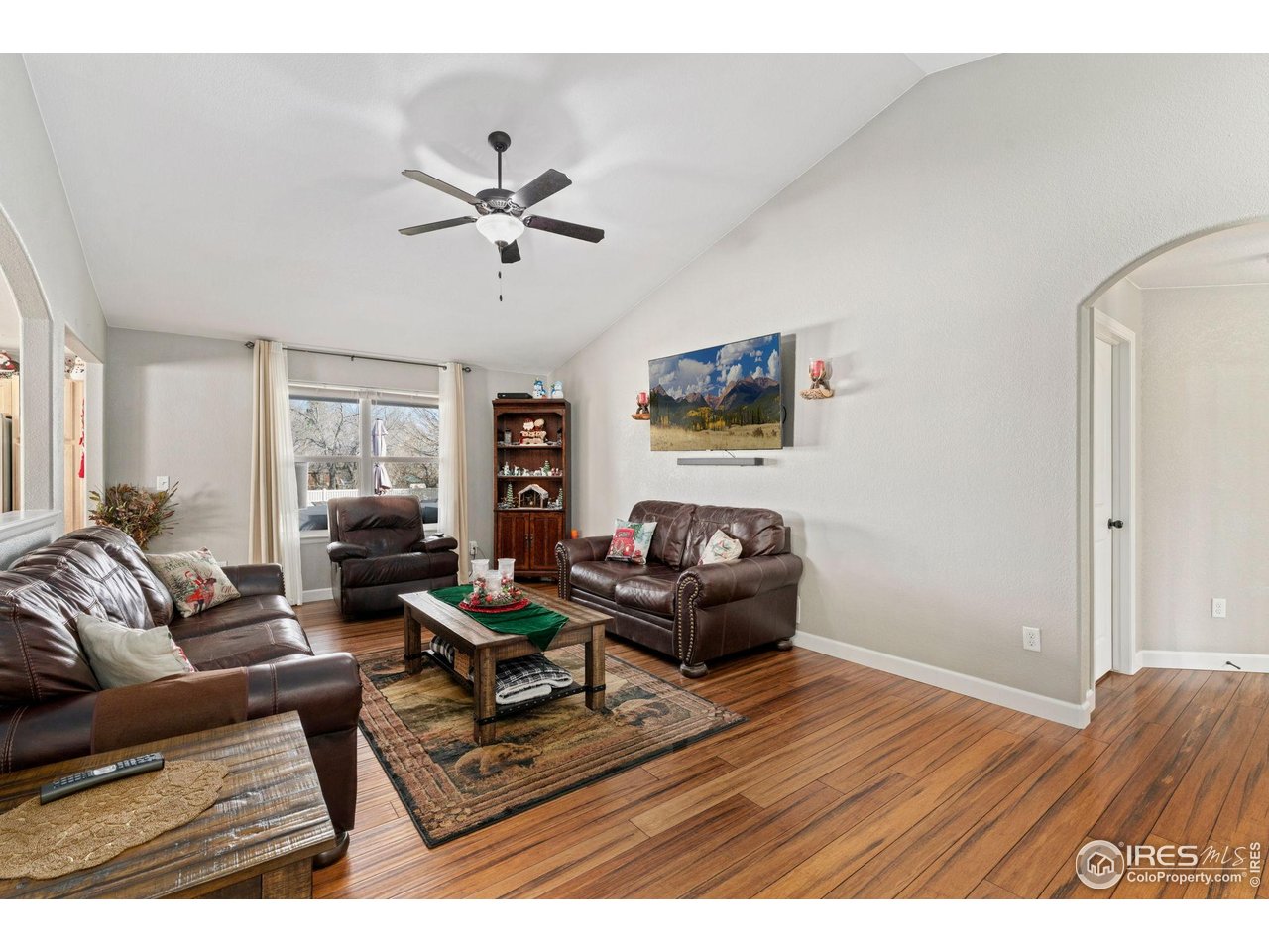 11420 Coal Ridge Street Firestone, CO 80504 - Photo 7 of 31 a living room with furniture and a flat screen tv
