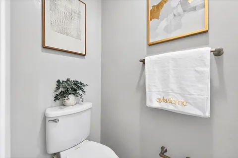 a white toilet sitting next to a bathroom sink