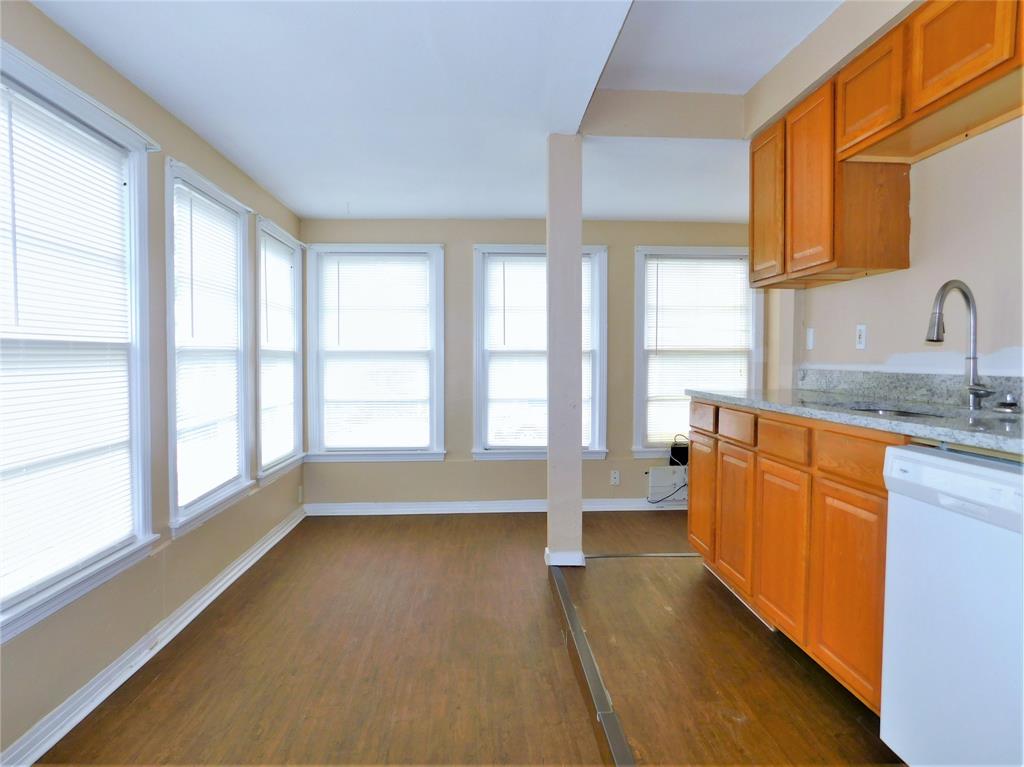 216 Maple Street, Unit 2 Denton, TX 76201 - Photo 6 of 16 a large kitchen with stainless steel appliances a large window