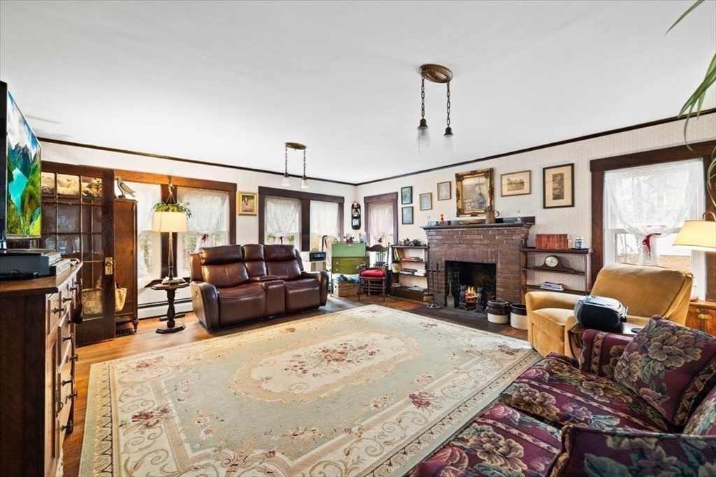 7 Shufelt Road South Walpole, MA 02071 - Photo 5 of 22 a bed room with furniture and a fireplace