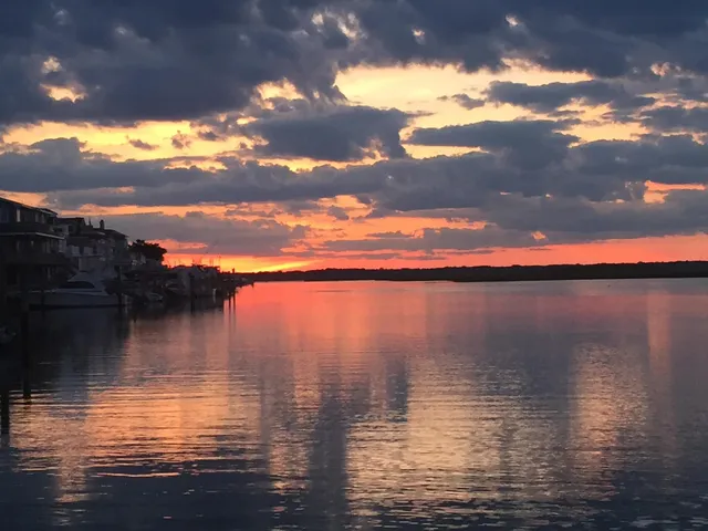 a view of a balcony with wooden floor next to a yard