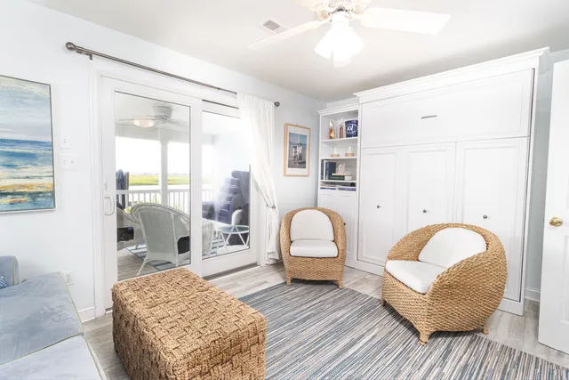 a living room with furniture a rug and white walls