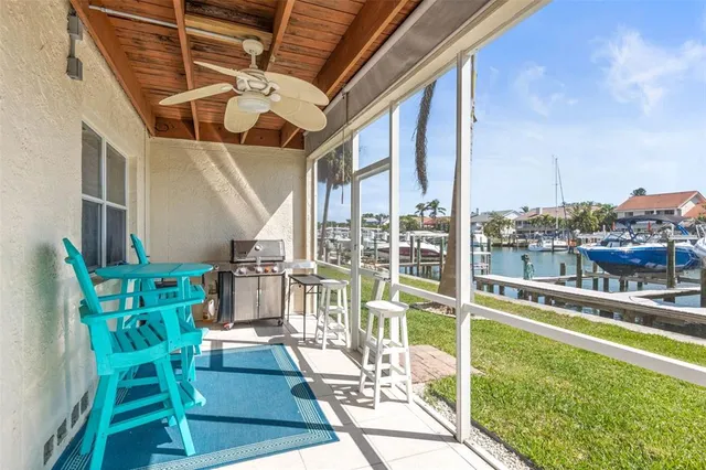 a view of a swimming pool with a patio and couches chairs