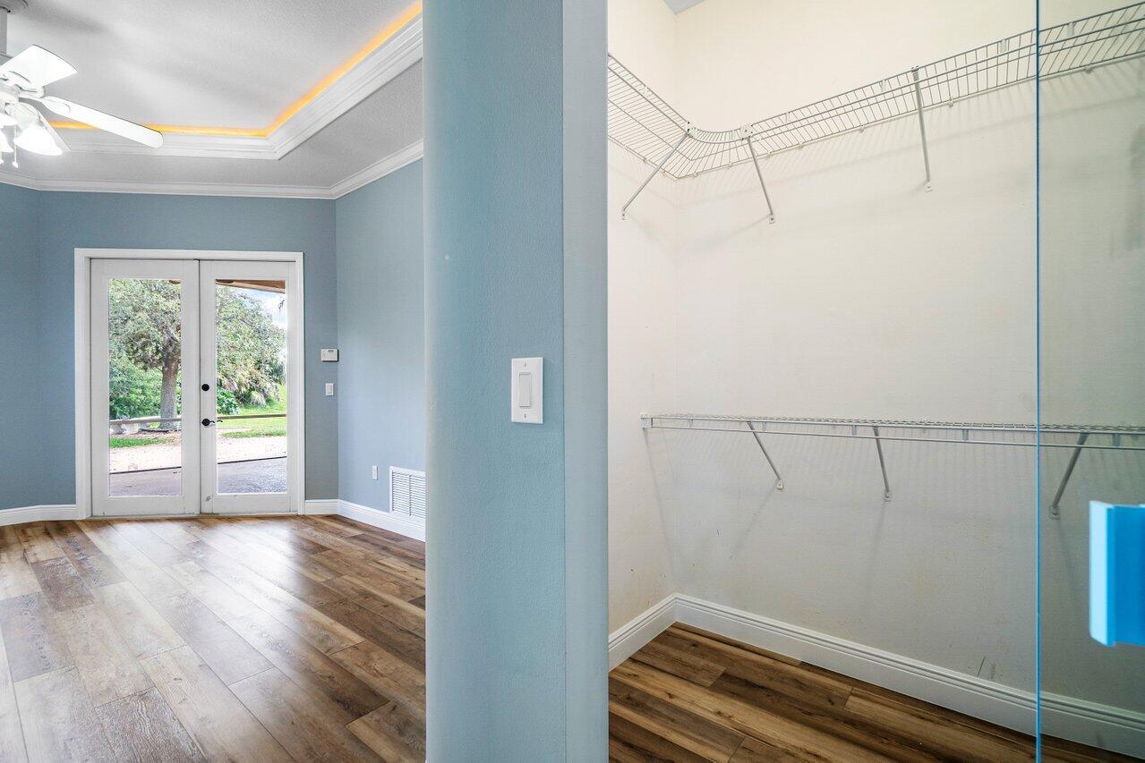 521 Southwest Lake Manatee Way Port St. Lucie, FL 34986 - Photo 17 of 33 a view of a room with racks on the wall