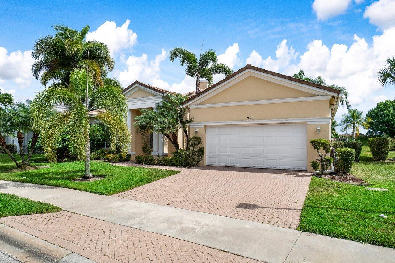 521 Southwest Lake Manatee Way Port St. Lucie, FL 34986 - Photo 2 of 33 a front view of house with yard and green space