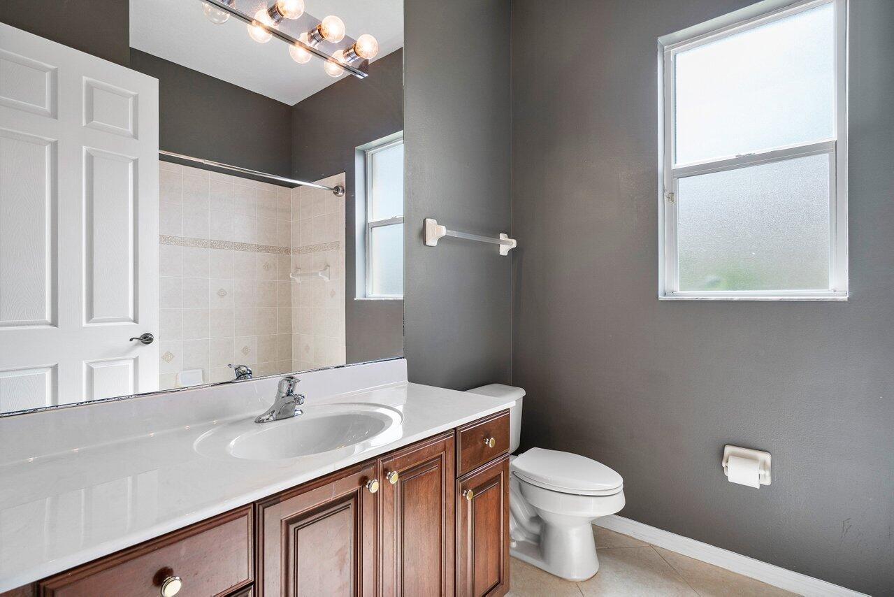 521 Southwest Lake Manatee Way Port St. Lucie, FL 34986 - Photo 23 of 33 a bathroom with a sink toilet and shower