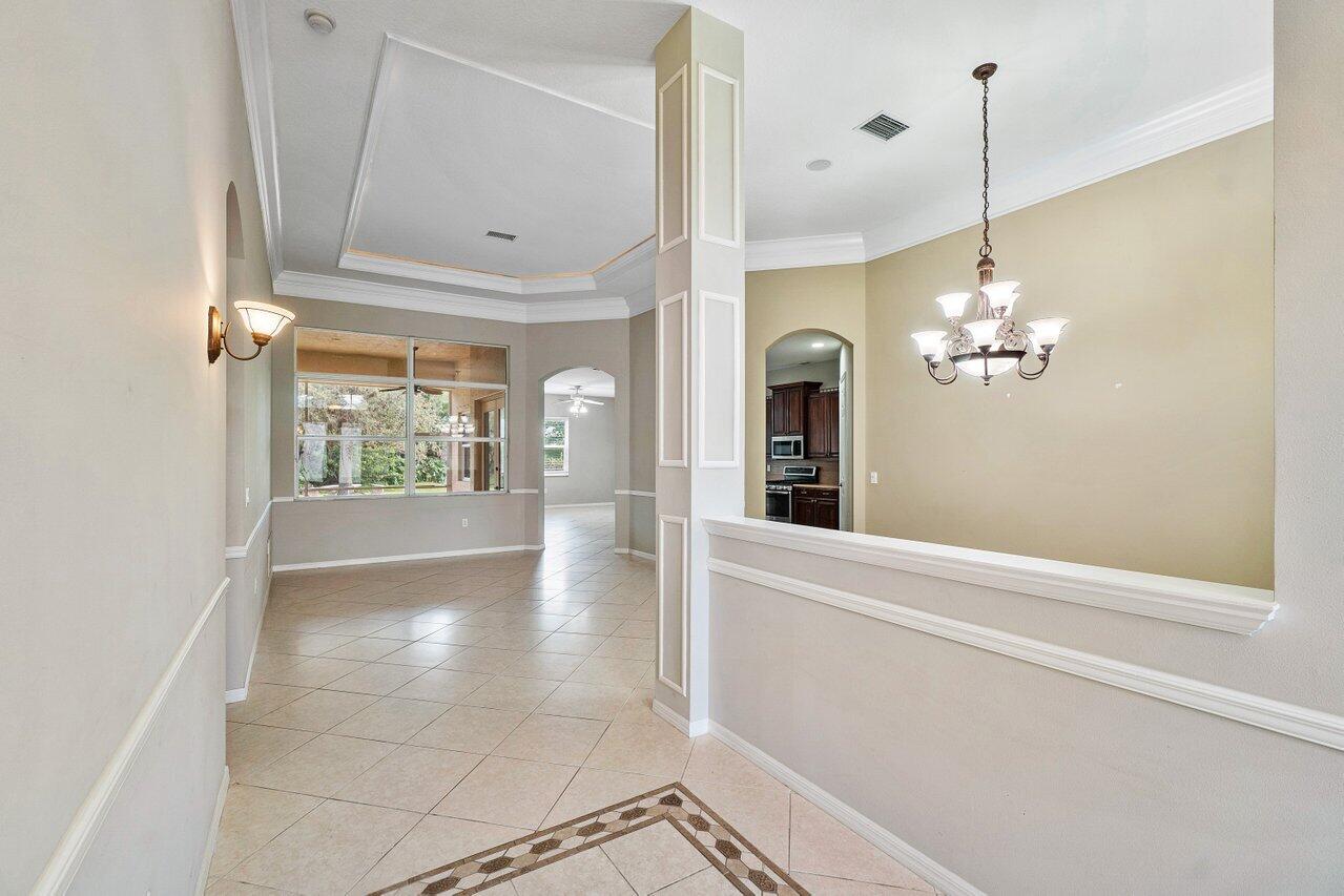 521 Southwest Lake Manatee Way Port St. Lucie, FL 34986 - Photo 25 of 33 a view of a room with a chandelier fan and windows
