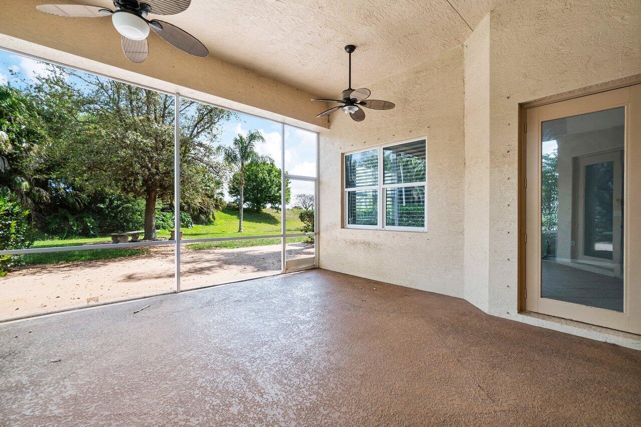 521 Southwest Lake Manatee Way Port St. Lucie, FL 34986 - Photo 26 of 33 a view of a house with porch and wooden floor