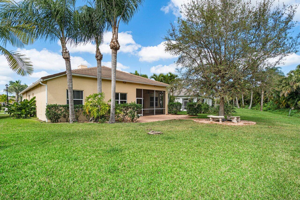 521 Southwest Lake Manatee Way Port St. Lucie, FL 34986 - Photo 30 of 33 front view of a house with a garden