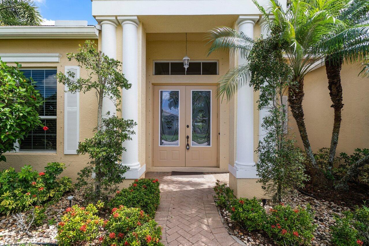 521 Southwest Lake Manatee Way Port St. Lucie, FL 34986 - Photo 3 of 33 a front view of a house with garden