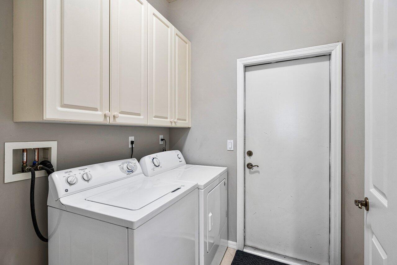 521 Southwest Lake Manatee Way Port St. Lucie, FL 34986 - Photo 33 of 33 a utility room with dryer and washer