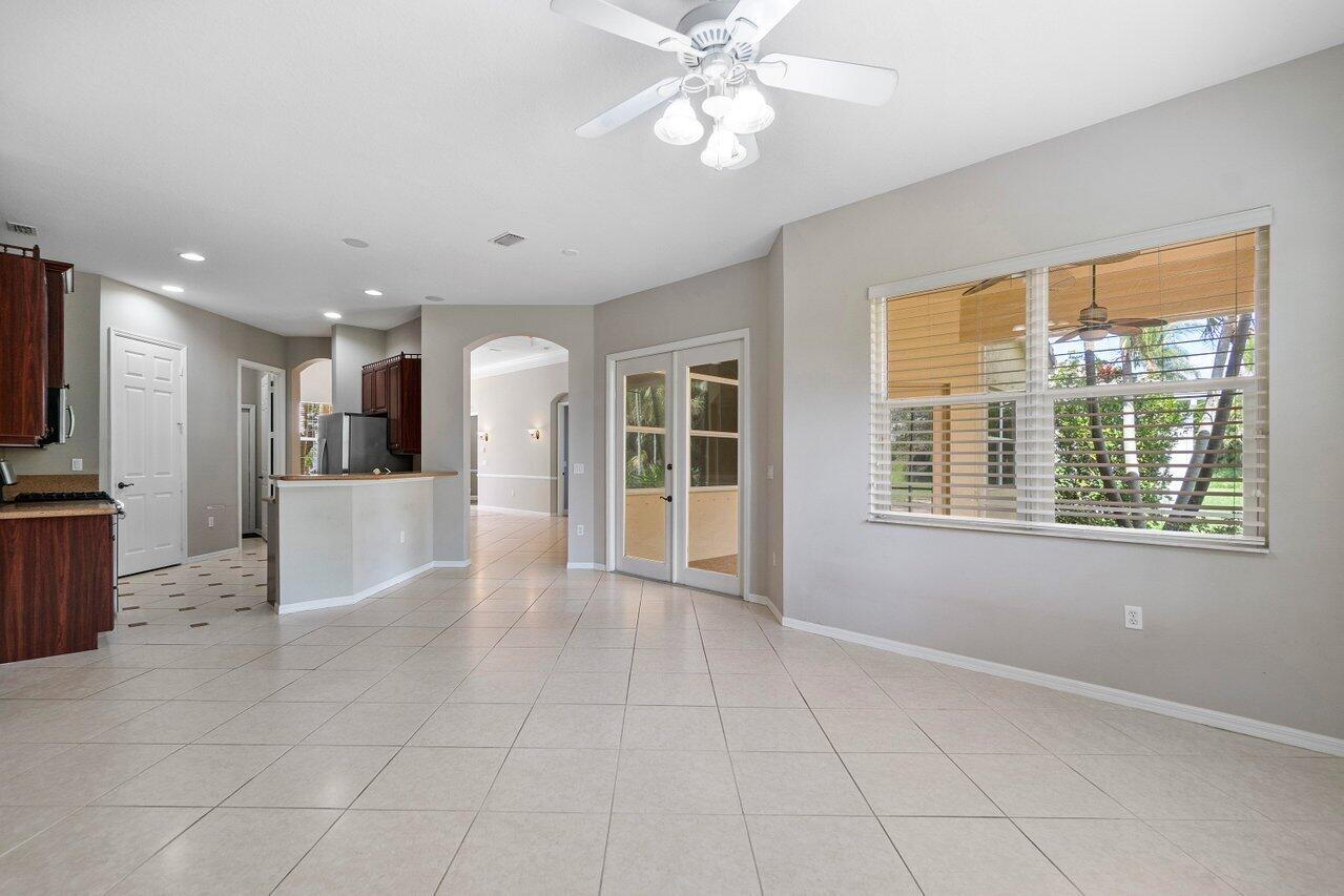 521 Southwest Lake Manatee Way Port St. Lucie, FL 34986 - Photo 8 of 33 a view of a kitchen with furniture and a window