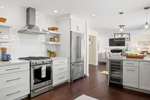 a kitchen with stainless steel appliances a stove a sink and a refrigerator