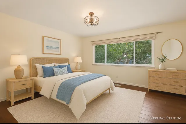 a bedroom with a bed and a large window