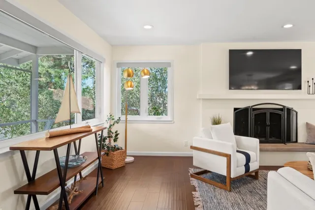 a living room with furniture a flat screen tv and a fireplace