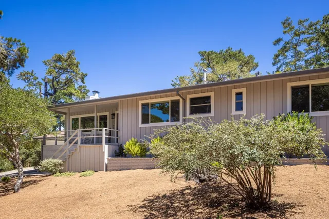 a view of a patio with couches table and chairs and potted plants