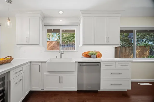 a view of cabinets a sink and dishwasher in a kitchen