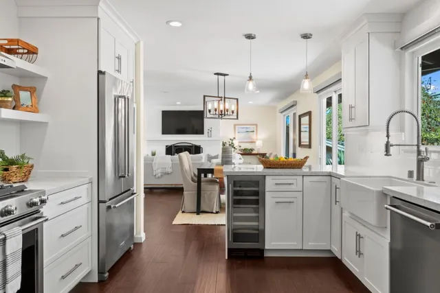 a kitchen with white cabinets and stainless steel appliances