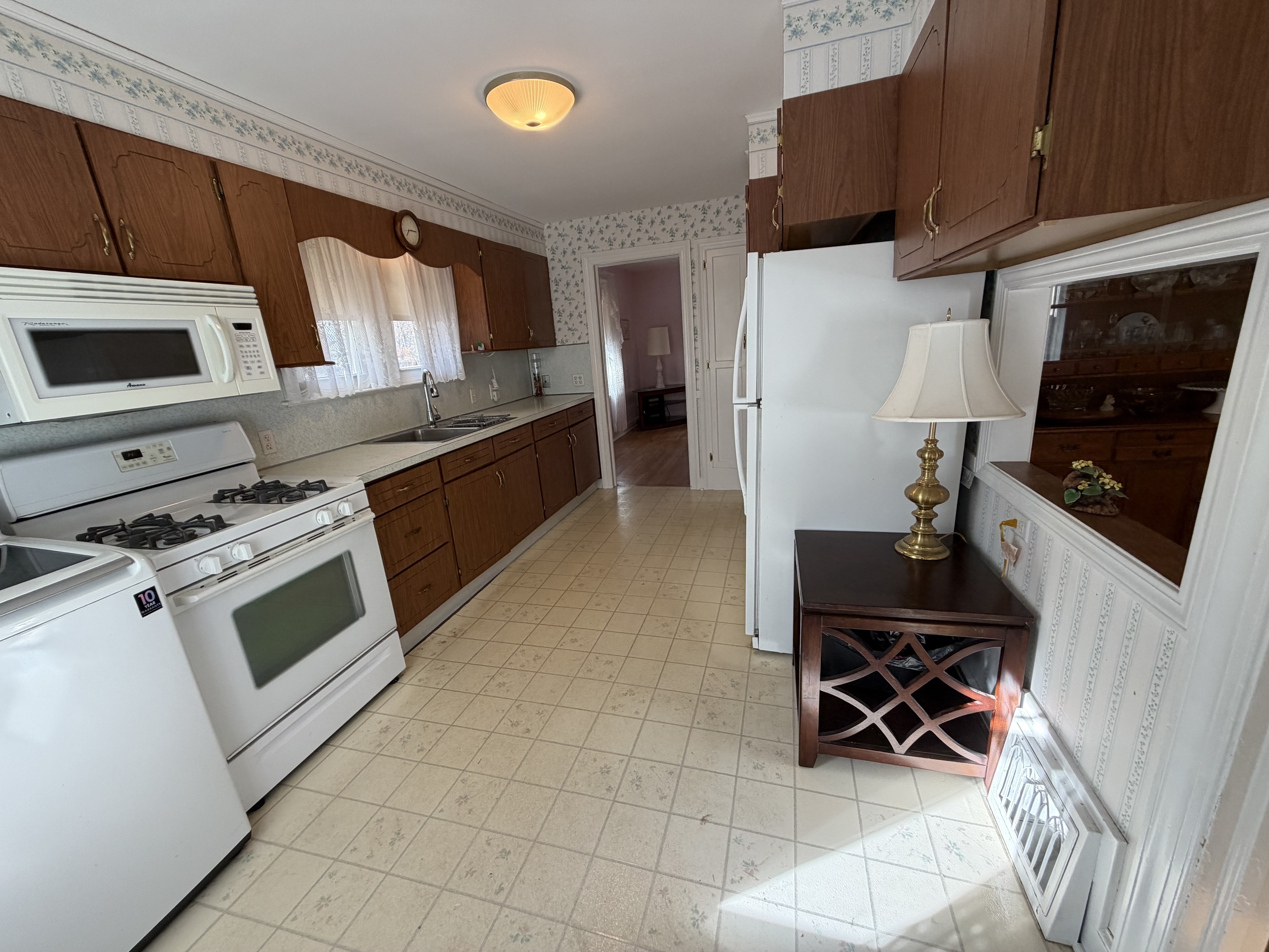 65 Clark Hill Road Prospect, CT 06712 - Photo 6 of 30 a kitchen with stainless steel appliances wooden cabinets and stove top oven