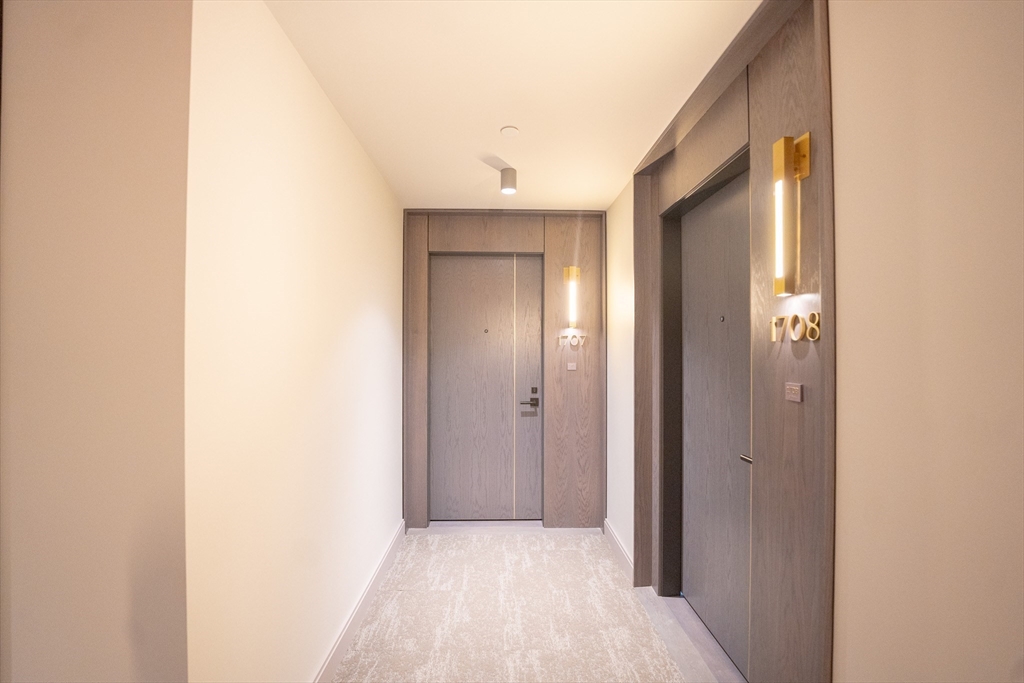 55 Lagrange Street, Unit 1708 Boston, MA 02111 - Photo 11 of 18 a view of a hallway with wooden floor