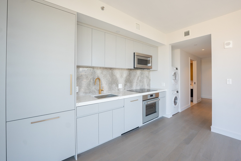 55 Lagrange Street, Unit 1708 Boston, MA 02111 - Photo 15 of 18 a kitchen with a sink cabinets and stainless steel appliances