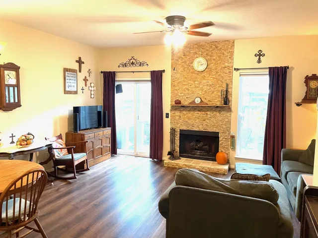 a living room with furniture and a fireplace