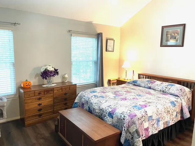 a bedroom with a bed and a dresser