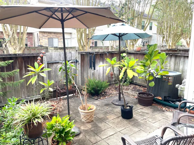 a view of a chairs and table under an umbrella