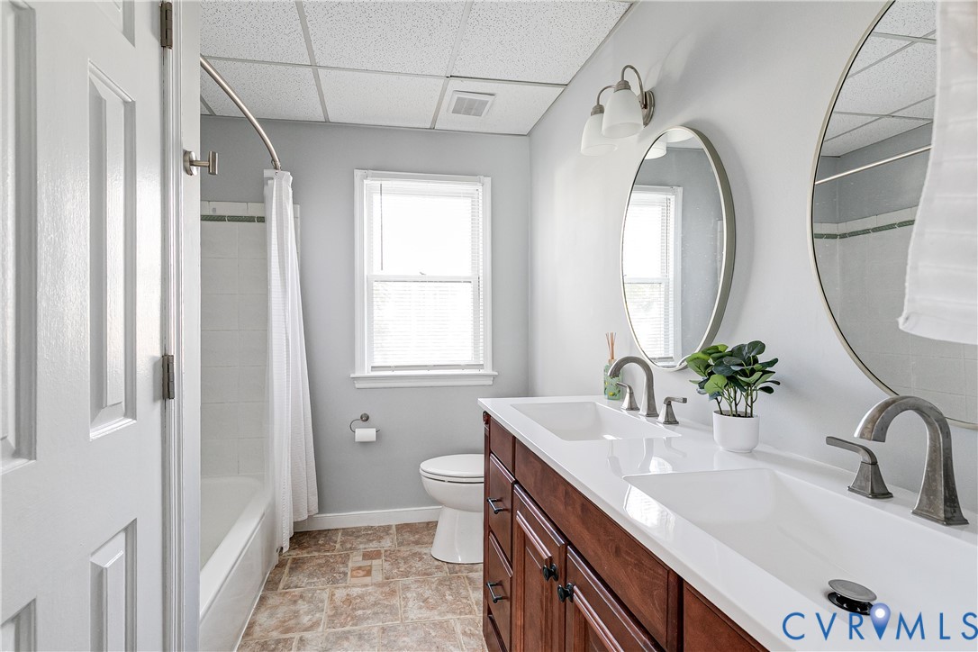 14710 Mill Spring Drive Midlothian, VA 23112 - Photo 13 of 24 a bathroom with a granite countertop sink a mirror and a shower
