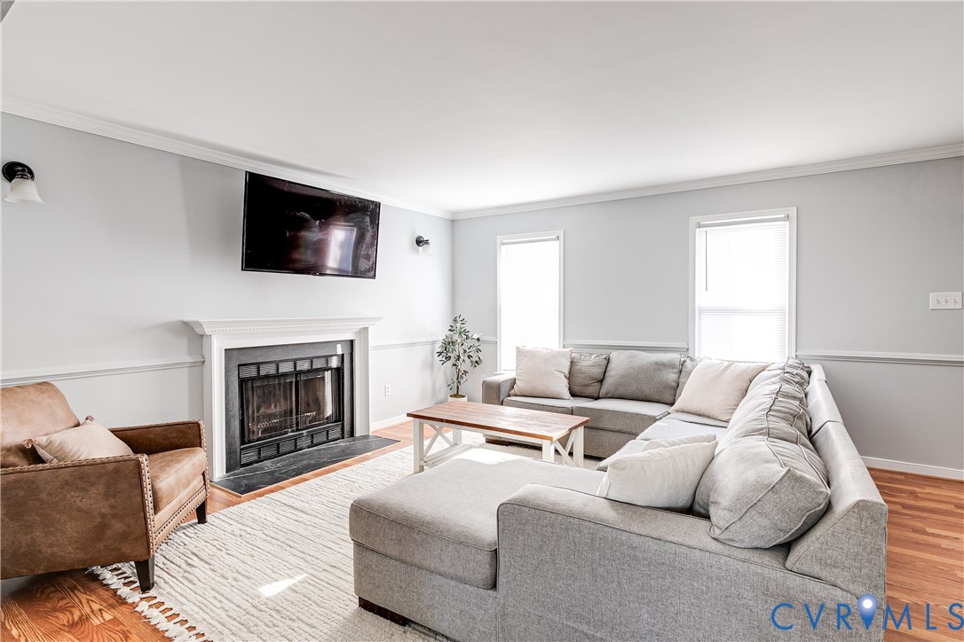 14710 Mill Spring Drive Midlothian, VA 23112 - Photo 5 of 24 a living room with furniture a fireplace and a flat screen tv
