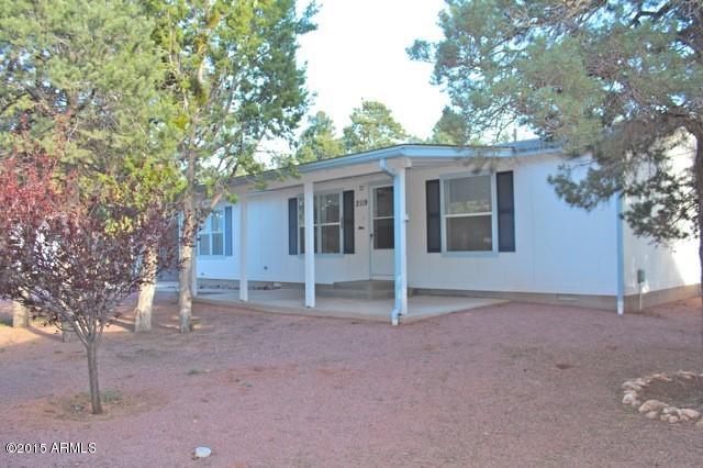 2119 Blue Jay Road Overgaard, AZ 85933 - Photo 1 of 28 a house with a tree in front of it