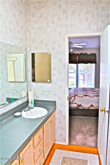 2119 Blue Jay Road Overgaard, AZ 85933 - Photo 13 of 28 a bathroom with a sink and a mirror