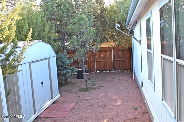 2119 Blue Jay Road Overgaard, AZ 85933 - Photo 17 of 28 a view of a house with a backyard and trees