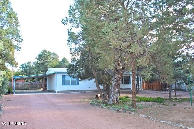 2119 Blue Jay Road Overgaard, AZ 85933 - Photo 28 of 28 a tree in front of a white house