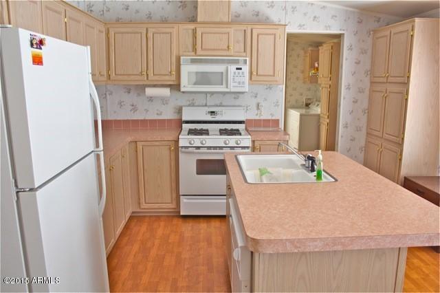 2119 Blue Jay Road Overgaard, AZ 85933 - Photo 5 of 28 a kitchen with a stove a refrigerator and a sink