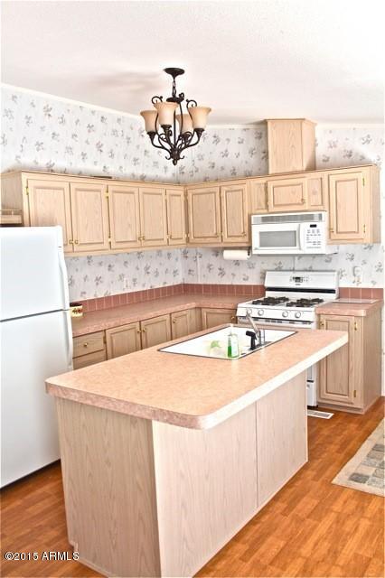 2119 Blue Jay Road Overgaard, AZ 85933 - Photo 6 of 28 a kitchen with a sink and a refrigerator
