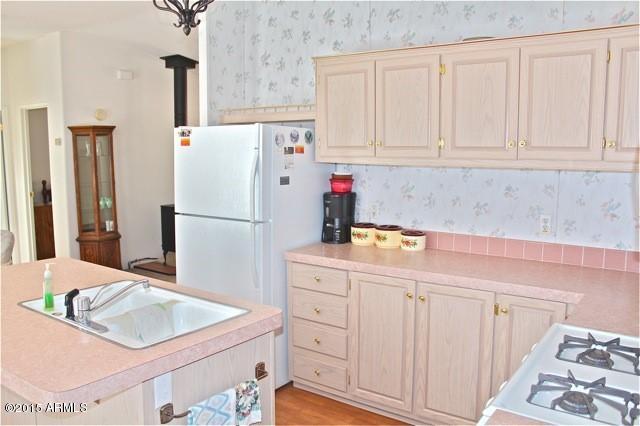 2119 Blue Jay Road Overgaard, AZ 85933 - Photo 7 of 28 a kitchen with stainless steel appliances granite countertop a sink and a refrigerator
