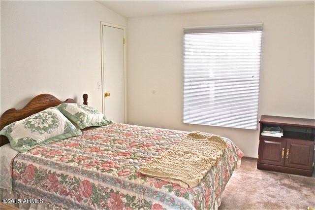 2119 Blue Jay Road Overgaard, AZ 85933 - Photo 10 of 28 a bedroom with a bed and a tv