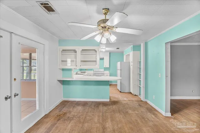 a kitchen with a sink cabinets appliances and a window