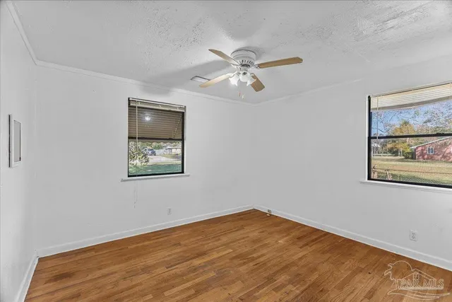 a view of a backyard with table and chairs and potted plants