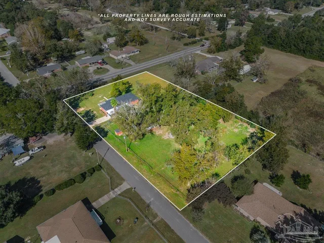 an aerial view of a residential houses with outdoor space