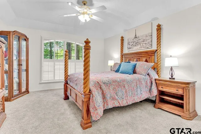a spacious bedroom with a bed and a chandelier