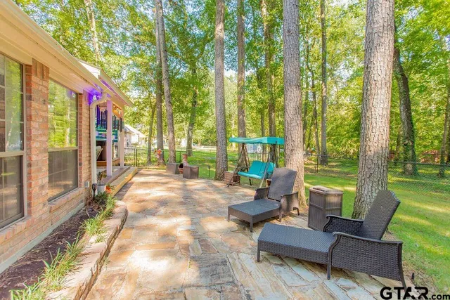 a house view with a sitting space and garden