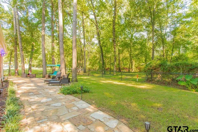 a view of yard with swimming pool and trees