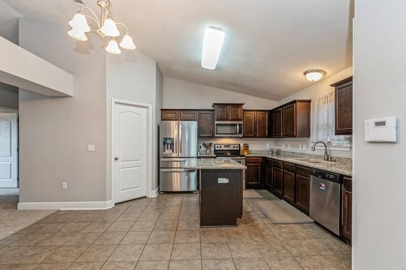 a large kitchen with stainless steel appliances lots of counter space cabinets and a sink