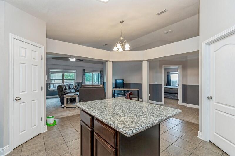 4640 Hermosa Road Crestview, FL 32539 - Photo 11 of 37 a kitchen with kitchen island a sink center island and a stove top oven