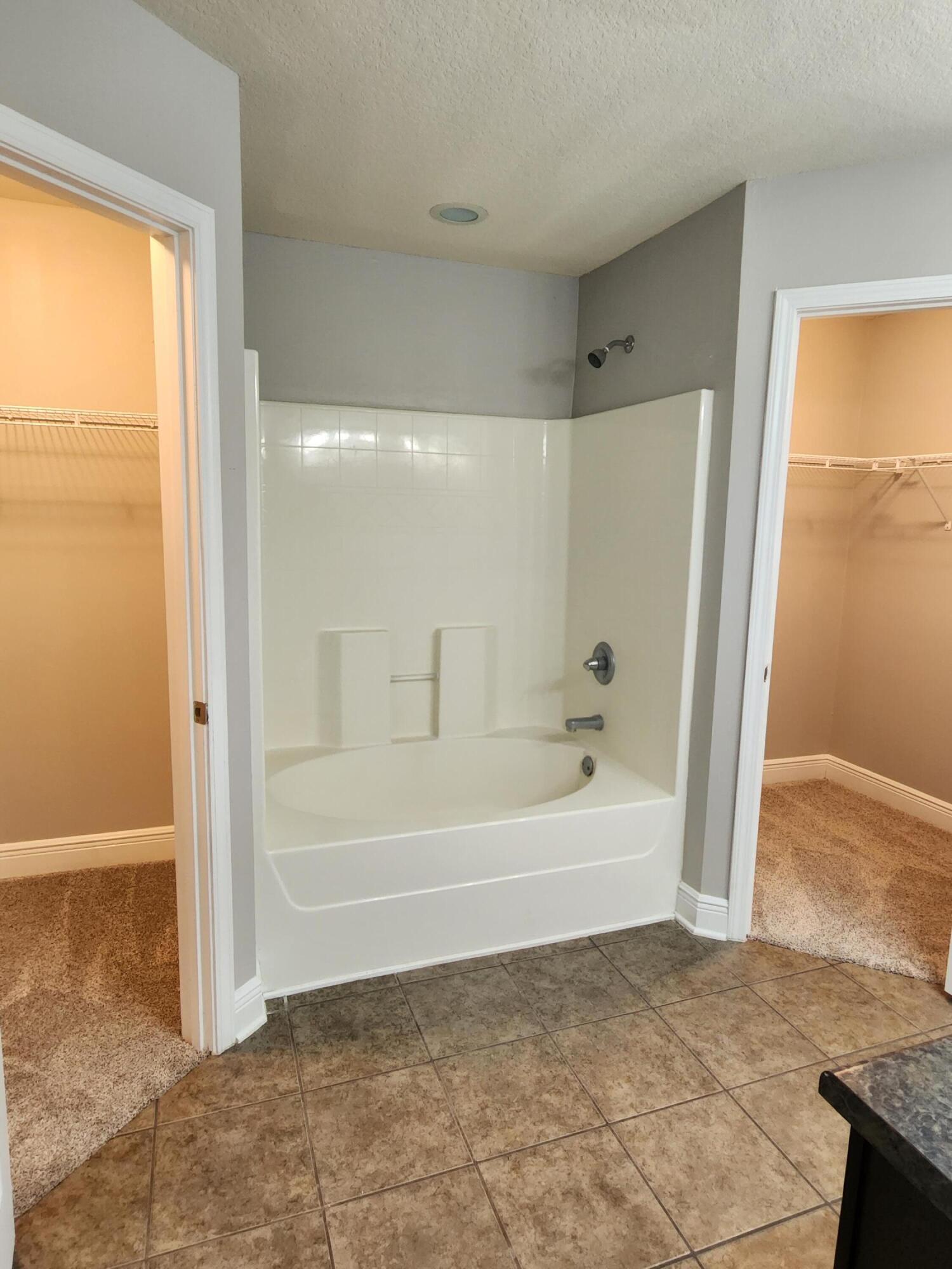 4640 Hermosa Road Crestview, FL 32539 - Photo 16 of 37 a bathroom with a bathtub and a shower