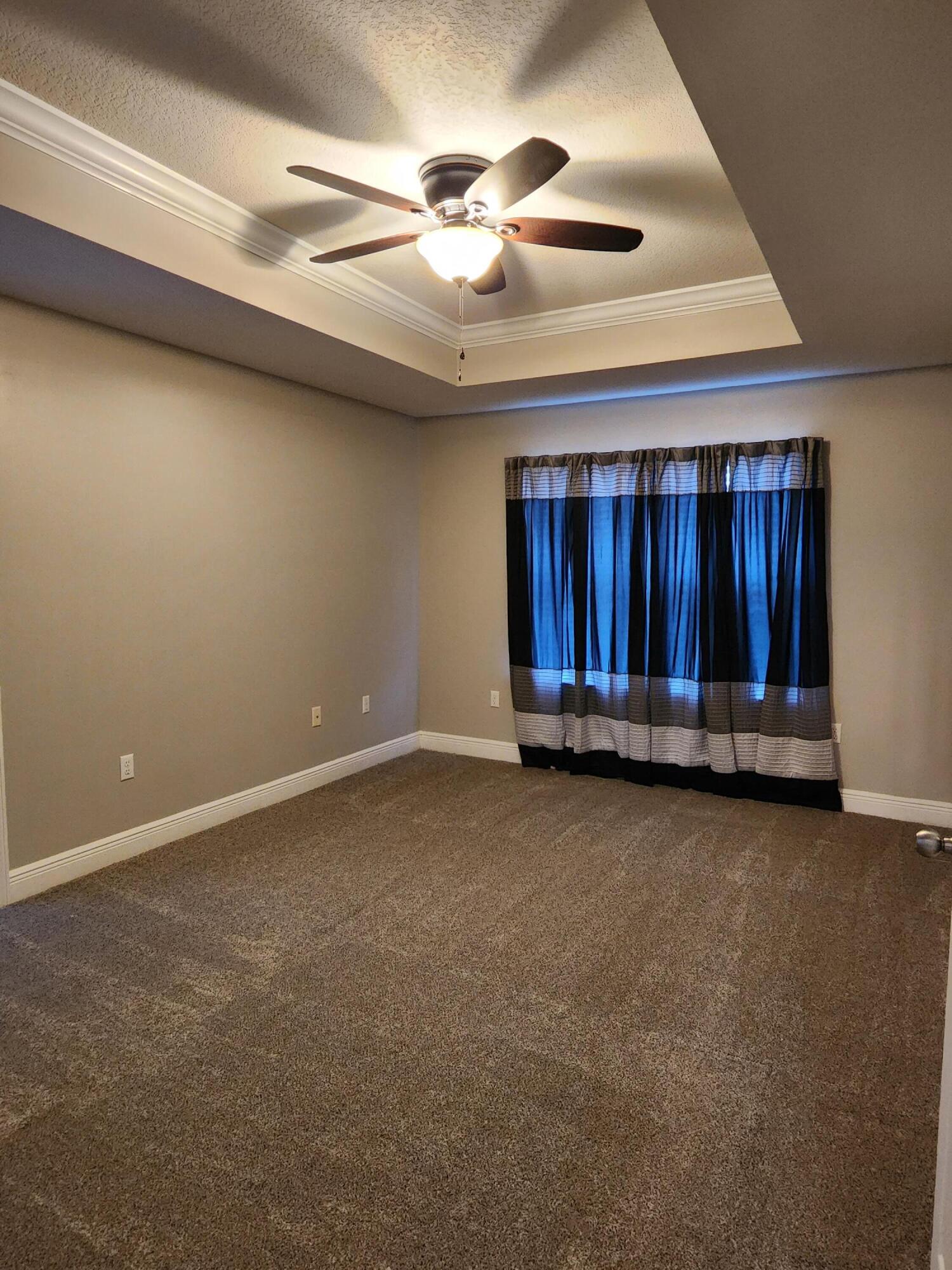 4640 Hermosa Road Crestview, FL 32539 - Photo 17 of 37 an empty room with windows and fan